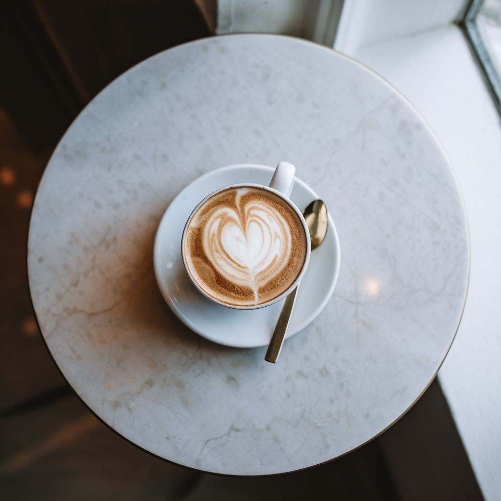 Latte art on a marble bistro table